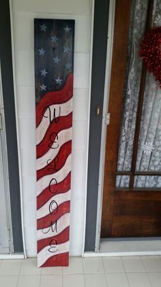 an american flag painted on the side of a door with words written in black and white