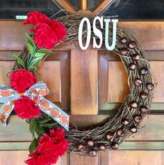 a wreath with the word osu on it and red carnations in front