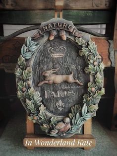 a carved wooden plaque with an animal on it