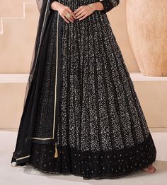 COLOR : Black FABRIC : Top - Pure Georgette, Dupatta - Net WORK : Silk Thread Embroidery, Digital Print, Sequins, Lace Border OCCASION : Party Wear, Festival READY-TO-WEAR : No STITCHING : Available as semi-stitched fabric, can be stitched using standard size option (+$30). Note: There might be a slight color variation due to lighting and flash used during photoshoot. The bright shade seen is the best closer view of fabric's color. Floor-length Embroidered Georgette Sets, Elegant Embroidered Maxi Choli, Elegant Embroidered Maxi Length Choli, Elegant Maxi Length Embroidered Choli, Floor-length Floral Embroidery Fitted Sets, Fitted Floor-length Sets With Floral Embroidery, Fitted Floral Embroidery Floor-length Sets, Semi-stitched Embellished Black Anarkali Set, Embroidered Semi-stitched Maxi Length Lehenga