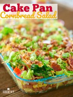 a casserole dish with bacon, lettuce and corn in it on a wooden table