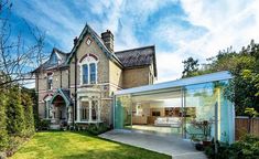 a large brick house with glass walls on the front