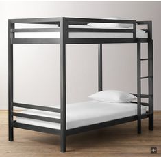 a black bunk bed with white sheets and pillows