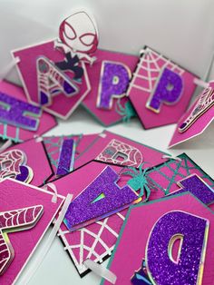 some pink and purple greeting cards with spiderman on them, one is for the letter d