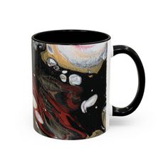 a black and white coffee mug with an abstract painting on it