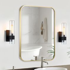 a bathroom sink sitting under a mirror next to a wall mounted faucet in front of a white bath tub