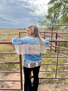 This one is a show shopper! This one is our FAVE! This denim is equipped with the perfect rhinestone fringe! This is a light-washed denim jacket, with two chest pockets, and two side pockets! This jacket is one for the books, and is sure to stand out in a crowd! For our plus sized ladies, sizing up would be ideal! Mariah is wearing XS SIZE CHEST LENGTH SLEEVE WIDTH SLEEVE LENGTH XS 19.75" 24.5" 4.5" 17.75" S 21" 24.5" 4.5" 18" M 21.5" 25.5" 4.75" 18.5" L 22.25" 26" 5" 18.5" XL 22.5" 27" 5" 19" 2 Festival Denim Fringe Outerwear, Denim Outerwear With Frayed Hem For Festival, Trendy Medium Wash Denim Jacket With Fringe, Fringe Denim Jacket In Medium Wash, Fall Denim Outerwear With Rhinestone Fringe, Denim Outerwear With Rhinestone Fringe For Fall, Casual Denim Jacket With Rhinestone Fringe For Fall, Rhinestone Fringe, Plus Sized