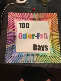 there is a sign that says 100 color - full days on the table with crayons