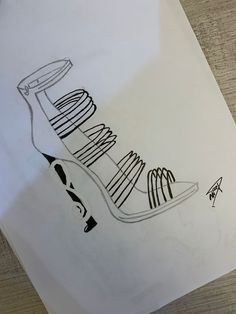 a drawing of a high heel shoe on paper