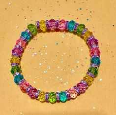 Handmade Easter beaded bracelet. Sparkling crystal-like spacer beads with clear pink, yellow, green, blue, and purple beads. Perfect gift for Easter, Mother's Day, or just enjoy it all year. Intended for adults, but would fit loosely on a child's arm. Stretch material used and no clasp. Triple knotted and glued to securely stay together with clear elastic stretch cord. Rainbow Crystal Bracelet With Colorful Round Beads, Multicolor Beaded Round Crystal Bracelet, Multicolor Beaded Crystal Bracelet, Rainbow Faceted Round Beads Bracelets, Multicolor Crystal Bracelet With Faceted Beads, Spiritual Multicolor Crystal Bracelet With Faceted Beads, Rainbow Crystal Bracelet With Round Beads For Gift, Rainbow Faceted Beads Bracelet For Jewelry Making, Multicolor Crystal Bracelet With Spacer Beads As Gift