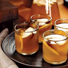 three glasses filled with liquid sitting on top of a table