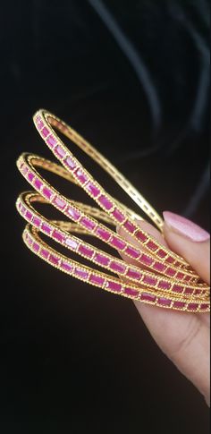 "* Handcrafted Gold Plated 4 Bangle Set. Sold as a set. * Bangles with high quality semi precious ruby stones. * High Quality 22K Gold Plated. Bangles Sizes : 2.4 inches= ( 2.25\" diameter of the inner circle) ; 2.6 inches = ( 2.42\" diameter of the inner circle); 2.8inches = (2.57\" diameter of the inner circle) The gorgeous gold-plated bangles set best exemplifies the careful craftsmanship done on it -- specially picked for you by Nemali Jewelry. It has a special tone of elegance attached to i Elegant Stackable Bangle For Festivals, Elegant Festive Stackable Jewelry, Adjustable Gemstone Bangle For Wedding, Gold Ruby Bracelets In Temple Jewelry Style, Gold Bangle With Gemstone For Festivals, Gold Ruby Bracelet In Temple Jewelry Style, Gold Gemstone Bangle For Festivals, Gold Ruby Bracelets For Party, Gold Ruby Bracelet For Party