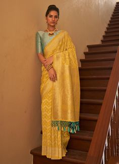 Make a statement with our Bollywood Style Yellow Nylon Crape Saree! The intricate weaving all over the saree and pallu creates a stunning, one-of-a-kind design. Complete with beautiful tassels attached on the sari pallu, it's the perfect gift for your special wife. Embrace the vibrant colors and luxurious fabric for a truly unforgettable look. The unstitched blouse can be customized upto 44 inches. Do Note: All the accessories shown are for styling purpose only. Slight color variation may occur Saree Ready To Wear, Classic Saree, Silk Drapes, Blouse Details, Yellow Saree, Ethnic Sarees, Green Saree, Tussar Silk Saree, Bridal Sarees