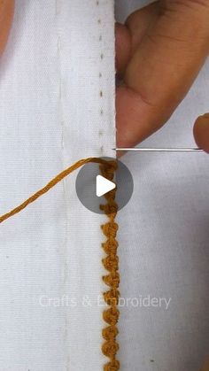 someone is stitching the end of a piece of fabric