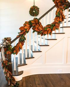 a wreath is hanging on the banister