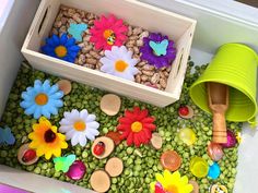 a box filled with lots of flowers and rocks