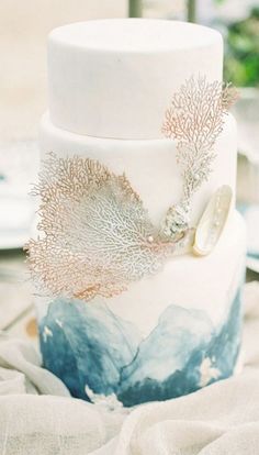 a white and blue cake sitting on top of a table