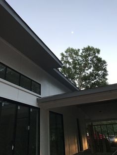 an outside view of a house with trees in the background