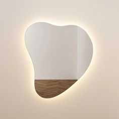 a heart shaped mirror mounted to the side of a wall