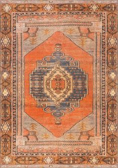 an orange, blue and beige rug with geometric design on the bottom half of it