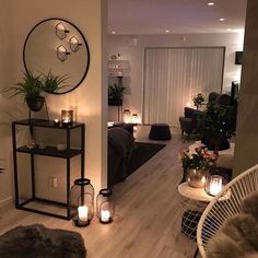 a living room filled with furniture and candles