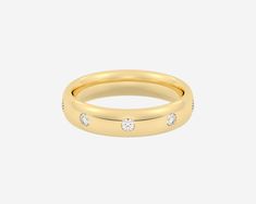 a yellow gold ring with three diamonds