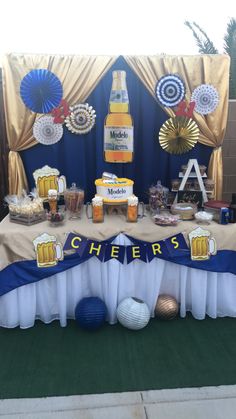 a table topped with lots of food next to a blue and white wall covered in decorations