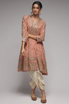 Editor's Note This pretty ensemble in this nusrat floral jaal, combines gota and dori buttis with an intricate border embroidery. The flared short kurta with a dhoti embroidered in sequins and gold thread, adds a feminine grace. Fabric: Kurta: georgette, dhoti: cotton Color: Pink Component: Dhoti and kurta Occasion: Festive Note: Product colour may slightly vary due to photographic lighting sources Care: Dry Clean Only About the Designer Gopi Vaid, co-founder of the eponymous label, is a designe Co Ords Outfits Indian, Gopi Vaid, Co Ords Outfits, Simple Kurti Designs, Color Combinations For Clothes, Dhoti Pants, Indian Fashion Designers, Embroidered Tunic, Embroidery Suits