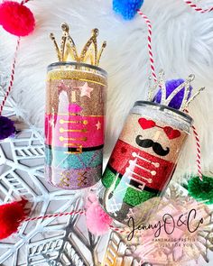 two tin cans decorated with glitter and mustaches