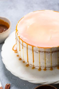 a cake sitting on top of a white plate covered in caramel drizzle