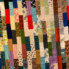 a multicolored patchwork quilt is displayed