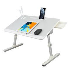 a computer desk with a mouse and tablet on it