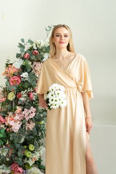 "Silk Toga Dress in Greek style. The dress was created from soft fabric with silk texure. Draped front style inspired by ancient Greek and Roman toga fashion. Due to the fabric, it is extra light and comfy to wear in the hot season. The design is very light and airy. A bit oversized cut is a great fit for the modest and ladylike image. The ruffle back with a V cut creates a delicate accent. Comfy to wear, move and dance. It is also festive and modest and suits for visiting the church ceremonies V-neck Maxi Dress For Wedding Night In Spring, Feminine Bridesmaid Dress With Surplice Neckline, Spring Pre-draped V-neck Maxi Dress, Evening Flowy Faux Wrap Dress, Flowy Faux Wrap Evening Dress, Flowy Wrap Evening Dress, Spring Bridesmaid Midi Dress With Surplice Neckline, Flowy Wrap Dress For Evening, Flowy Wrap Party Dress