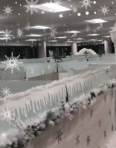 snowflakes are hanging from the ceiling in an office building