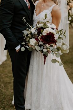 a bride and groom pose for a wedding photo