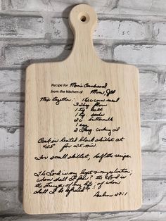 a wooden cutting board with writing on it