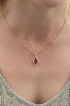 Unique amethyst pendant with a drop style kite shape. The center gemstone is suspended in a floating halo, so movement and light can make this amethyst dance! 14k Yellow Gold, 18" Chain with lobster clasp .17tw VS Natural Diamonds 1.00ct Natural Amethyst Gold Pendant Designs, Simple Elegant Necklace, Amethyst Jewellery, Gold Chain With Pendant, Amethyst Jewelry, Jewelry Lookbook, Amethyst Necklace, Amethyst Pendant, Fantasy Jewelry