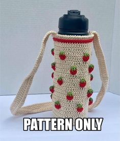 a crocheted strawberries and apple pattern water bottle cover is shown on a white surface