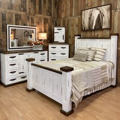 a bed room with a neatly made bed and dressers