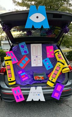 the trunk of a car has been decorated with letters and decorations for an upcoming birthday party