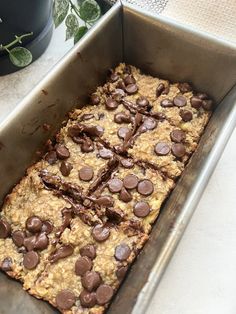 a pan filled with chocolate chip oatmeal bars on top of a counter