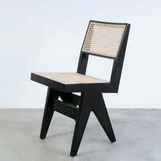 a black chair with woven seat and back