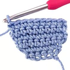 the crochet hook is being used to hold the knitting stitchs in place