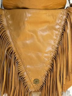 This remarkable, handcrafted leather fringe boho handbag is an absolute showstopper! Meticulously crafted with love, this unique bag is a must-have for any boho-enthusiast. Its captivating, detail will make a bold statement. Just drape the bag over your shoulder and prepare to turn heads with its effortless fashion. Hancrafted Genuine Leather Lined Feature Stone Zip Close Adjustable Cross Body Strap Stud detail Inside bag has a zip pocket and two open pockets for keys, phone, lipstick etc Measurements : Approx W29cm x H30cm Please keep in mind that leather is a natural product and colour variations & marks in the hide are not considered faults but make each piece unique & individual. Leather Fringe Hobo Bag For Festivals, Bohemian Leather Hobo Bag With Tassels, Festival Fringe Hobo Shoulder Bag, Bohemian Leather Shoulder Bag With Fringe, Festival Fringe Hobo Tote Bag, Vintage Leather Bags With Fringe, Brown Fringe Hobo Bag For Festival, Festival Brown Hobo Bag With Fringe, Festival Brown Fringe Hobo Bag