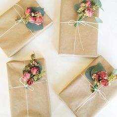 four wrapped gift boxes with flowers on them