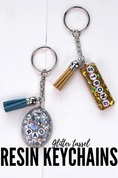 two key chains with different designs on them and the words resinin keychains