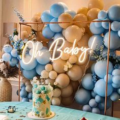 a blue and white dessert table with balloons on the wall behind it that says oh bake