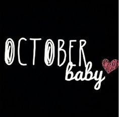 the words october baby written in white chalk on a black background with a red heart