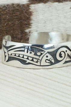 This sterling silver bracelet was made by Hopi silversmith Timothy Mowa. The inside is signed and stamped sterling.Size: 5 3/4" (will fit up to a 6 1/4" wrist)Gap: 3/4"Width: 3/4"Free shipping on all orders! We ship with USPS and always include tracking. All orders ship within a day of payment.Returns are accepted up to 30 days after you receive your order. Just send us a message. Our shop offers cash back or store credit. The item must be returned in new condition. Symbolic Stamped Silver Bracelets, Etched Sterling Silver Bracelet For Formal Occasions, Unique Sterling Silver Bracelets For Ceremonial Occasions, Sterling Silver Etched Jewelry For Ceremonial Occasions, Adjustable Symbolic Sterling Silver Cuff Bracelet, Ceremonial Sterling Silver Bracelets, Formal Etched Sterling Silver Bracelet, Stamped Sterling Silver Bangle Cuff Bracelet, Sterling Silver Collectible Bangle