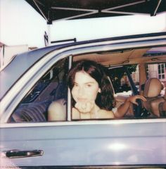 a woman sitting in the passenger seat of a car